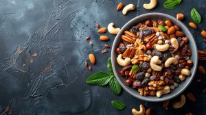 A bowl filled with a variety of nuts and fresh mint leaves, creating a visually appealing and healthy snack option.